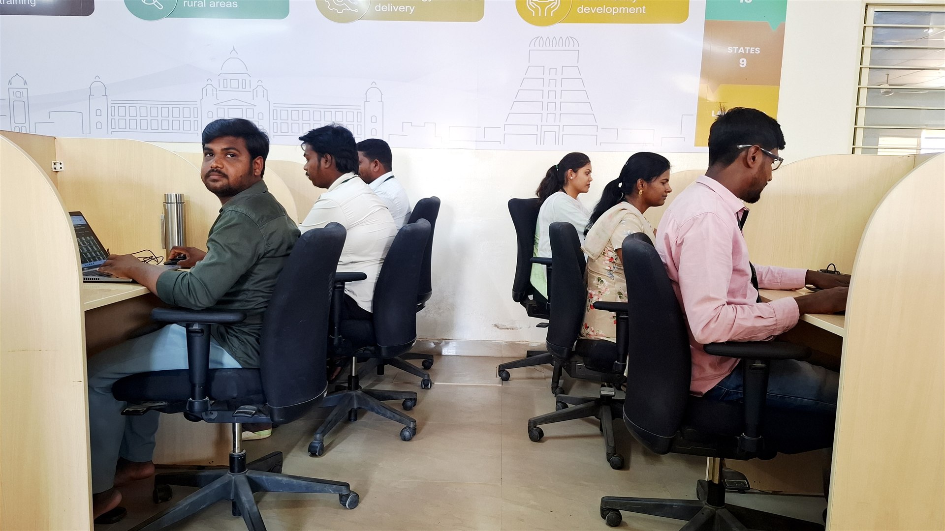 RuralShores employees collaborating in a modern workspace