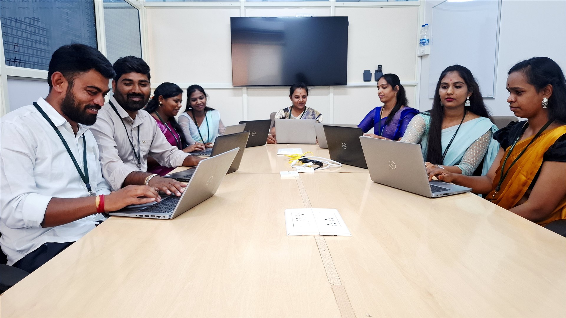 RuralShores employees learning together with laptops